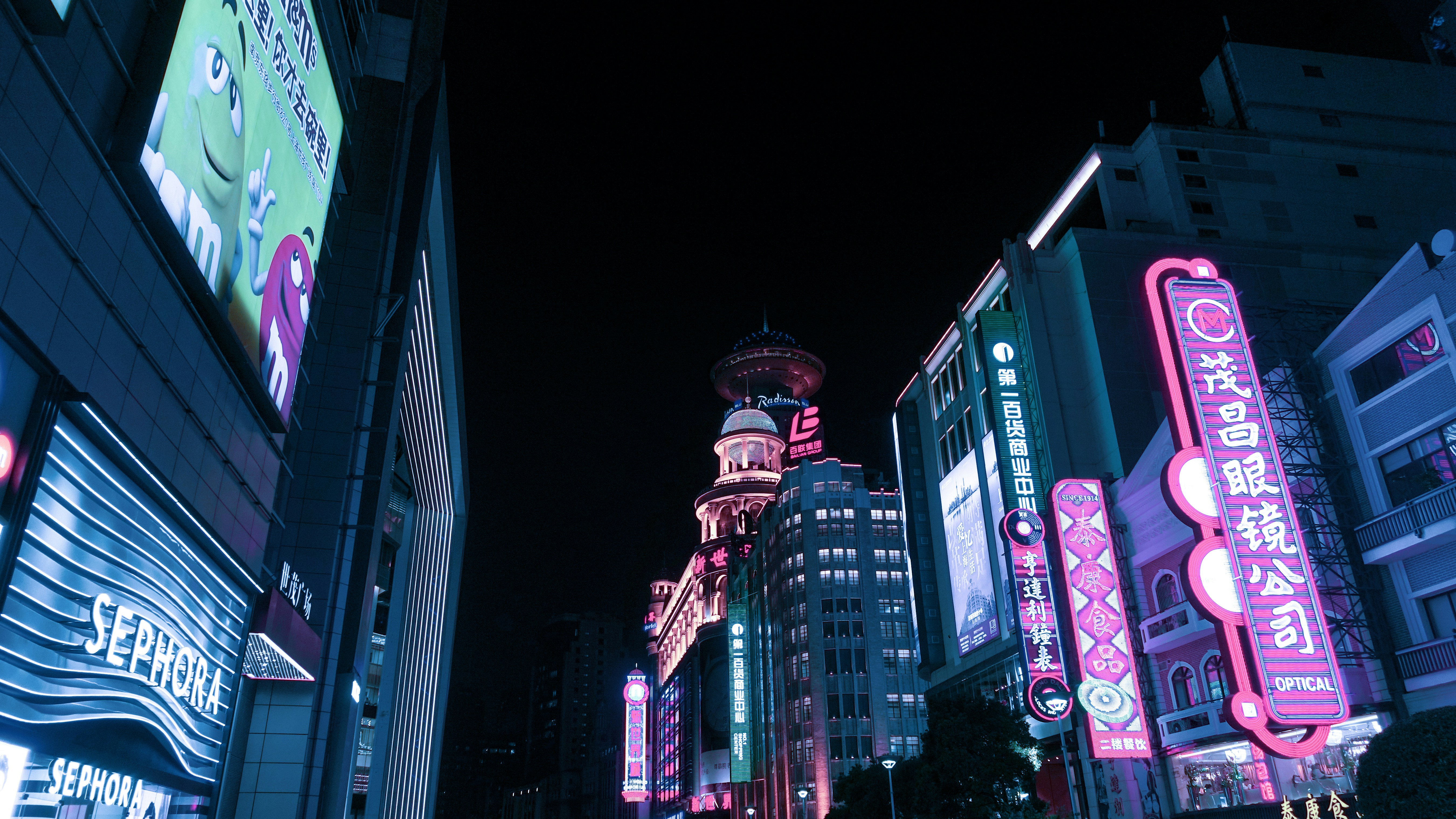 Nanjing Road at night with neon lights and crowds